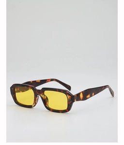 Detail view of retro rectangle tortoiseshell sunglasses with vibrant yellow lenses