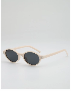 Detail of retro oval sunglasses featuring cream frames and dark grey UV lenses