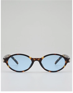 Close-up of retro oval tortoise shell frames with light blue lenses and silver metal hinges