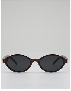 Detail of tortoise shell oval sunglasses featuring a silver metallic temple hinge accent