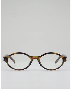 Detail view of oval tortoise shell sunglasses with retro leopard texture and silver hinges