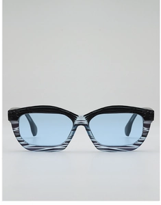 Detail of square sunglasses with blue lenses and unique zebra stripe pattern frames