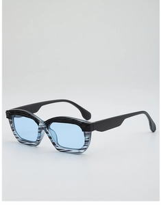 Detailed close-up of blue transparent lenses and irregular black striped sunglasses frames