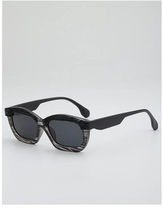 Detail view of irregular geometric sunglasses with grey marble texture and black matte temples