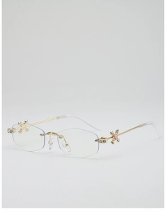 Vue détaillée de lunettes sans monture avec décor de croix en diamant et pierre rose