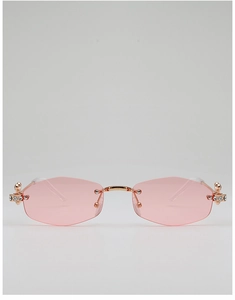 Détail de lunettes de soleil polygonales sans monture roses avec strass et métal or rose