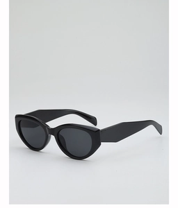 Close-up of black cat-eye sunglasses featuring wide geometric temples and dark UV lenses