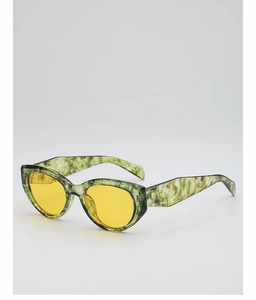 Detail view of cat eye sunglasses with green marble texture frames and yellow lenses