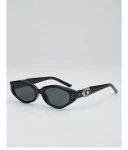 Detail of vintage cat-eye sunglasses featuring silver hollowed temple with a clear gem