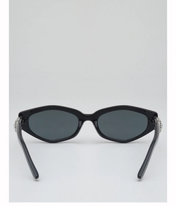 Detail view of small polygonal sunglasses with silver hinge accents and dark lenses