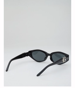 Close-up of hexagonal sunglasses with silver hollow decoration and inset rhinestone