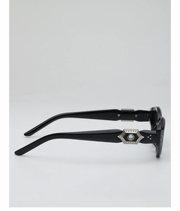 Close-up of black acetate sunglasses arm featuring silver hexagonal metal with clear gem