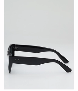 Close-up of black oversized sunglasses showing silver metal rivets and polished temples