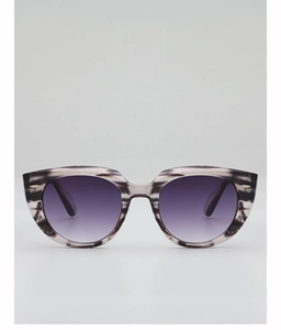 Detail of cat-eye sunglasses featuring marble textured frames and purple gradient lenses