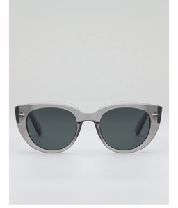 Close-up of retro cat-eye sunglasses with translucent grey frames and metal rivet details
