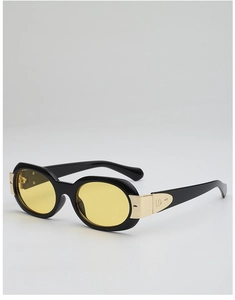 Détail de lunettes de soleil ovales avec monture noire, verres jaunes et logo LD en métal doré