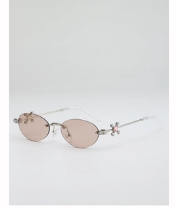 Detail of rimless oval sunglasses featuring cross hinge with pink gemstone and rhinestones