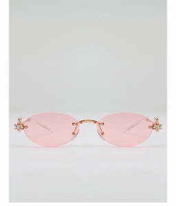 Detailed view of pink oval rimless sunglasses with rose gold floral rhinestone accents