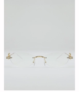 Detailed close-up of oval rimless sunglasses featuring golden metal joints and rhinestone accents