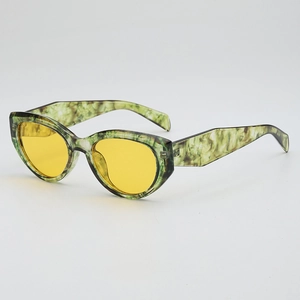 Cat eye sunglasses with green marble frame and yellow lenses in a side view