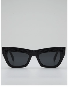Detail of black cat-eye sunglasses featuring embossed wave texture on the thick frames