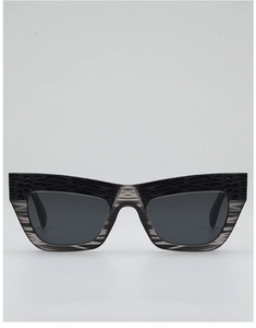 Detail of cat-eye sunglasses with textured black frame and striped translucent accents