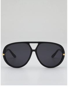 Macro detail of aviator sunglasses with gold metal accents and triangle bridge cutout
