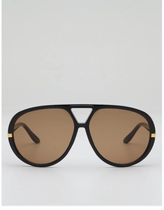Detail of pilot sunglasses with double-bridge frame and gold metal temple accents