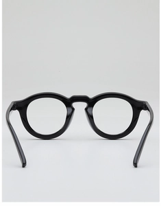 Detail shot of classic black round glasses frame with minimalist keyhole bridge design