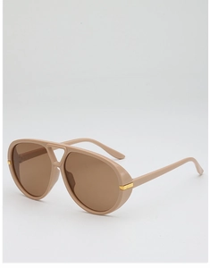 Detail of nude pink pilot sunglasses featuring amber lenses and gold temple accents