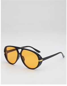 Detail of vintage double-bridge aviator sunglasses with yellow lenses and black frame