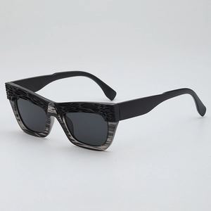 Retro cat-eye sunglasses with textured black and gray frame at a 45-degree angle view