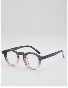 Detail of round eyewear frame showing a smooth gradient from dark grey to translucent pink