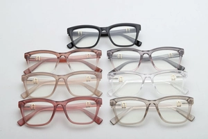 Detail of square glasses frames in seven colors with gold U-shaped metal accents