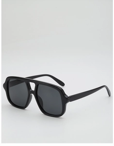 Detail view of large black pilot sunglasses with premium glossy frame and dark lenses