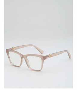 Detail view of square frame glasses in transparent champagne finish with golden metal hinges