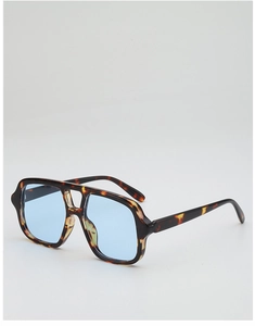 Detail of tortoise frame sunglasses with blue lenses and double bridge design