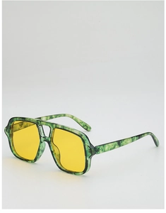 Detail of green marble aviator frame with yellow lenses and double bridge design