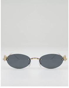 Close-up of luxury oval rimless sunglasses with rhinestone Saturn crown detail