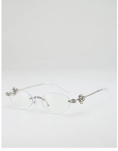 Detail of oval rimless sunglasses with silver metal temples and sparkling crystal accents