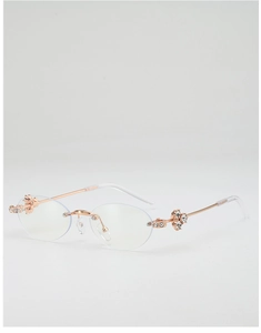 Detailed close-up of rose gold oval sunglasses featuring floral rhinestone accents