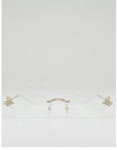 Detailed macro view of gold metal bridge and rhinestone hinges on oval rimless sunglasses