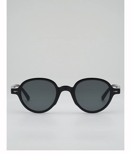 Close-up of black matte round sunglasses featuring silver diamond-shaped metal accents