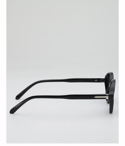Detail of black square sunglasses featuring a silver metallic hinge inlay and thick frame
