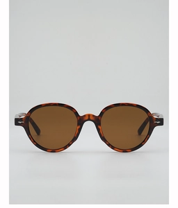 Detail of round tortoiseshell sunglasses with brown lenses and silver diamond accents