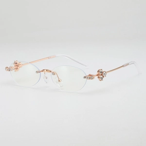 Luxurious rimless oval sunglasses with rose gold metal temples and sparkling rhinestone floral