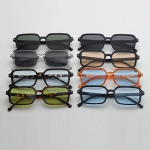 Flat lay of retro square sunglasses collection in multiple colors with metal hinge details