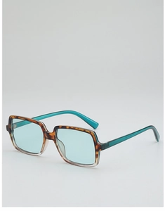 Detail of oversized retro sunglasses with tortoiseshell and teal contrast frames