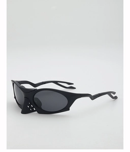 Close-up of matte black sports sunglasses with cyberpunk nose guard and bolt legs