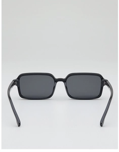 Detail view of stylish square black frame sunglasses with dark tinted lenses on white background